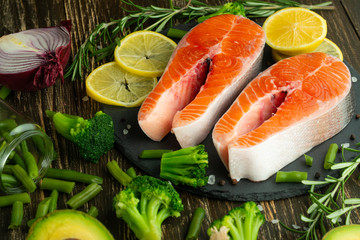 Fresh fish steak trout, salmon, salmon, red fish meat. With ingredients and vegetables on a wooden background, Flat-lay, Clean and healthy food.vegetarian