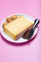 Piece of aged Comte or Gruyere de Comte, AOC French cheese made from unpasteurized cow's milk in the Franche-Comte region of eastern France with traditional methods of production.