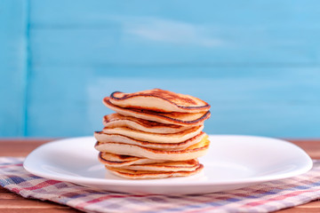 Stack of pancakes on blue background