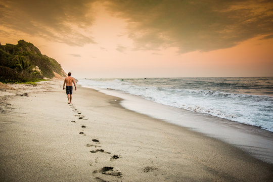 Man walking on the beach in Tayrona National Park