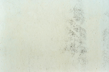 White wall with a beige yellowish color with a rough texture and a faded wash to the concrete. Background