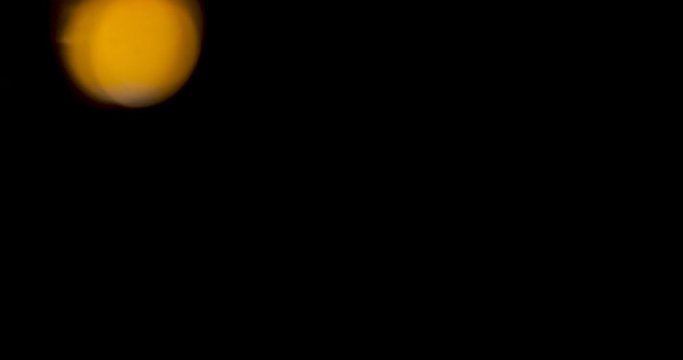 Glowing led lights inside a transparent jar in the darkness. Bokeh blurry
