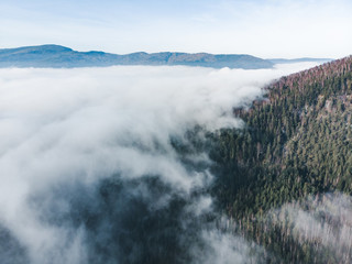 aerial view of clods and fog over mountains hills. magic time