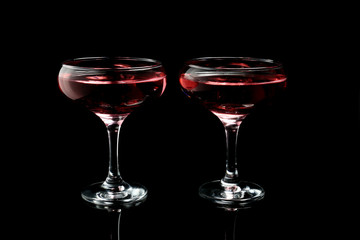 Glasses of tasty champagne on dark background
