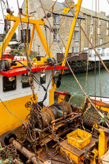 Yellow and Red Fishing Boat Moored in Polperro Harbour, Cornwall.