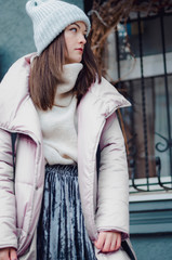 shopping, street fashion, style, people concept - model woman posing for photo outdoor. stylish...