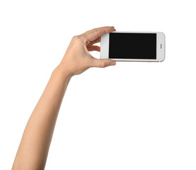 Young woman holding mobile phone on white background