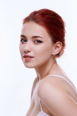 Obraz premium Beautiful face of young adult woman with clean fresh skin - isolated on white