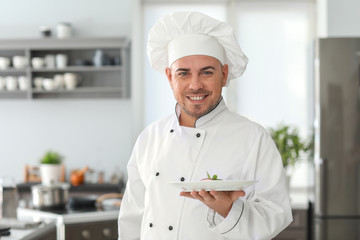 Male chef with tasty dessert in kitchen