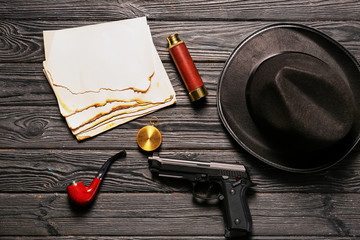 Composition with different items for detective on wooden background