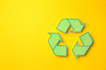 Recycling symbol on color background