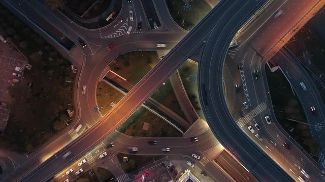 Timelapse zoom out of evening traffic on street intersection oval roundabout in Sochi, Russia Drone shot. Aerial view
