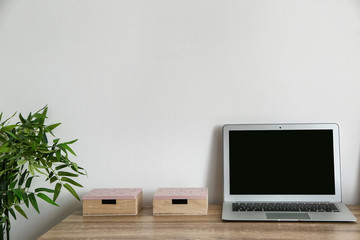 Comfortable workplace with modern laptop in room