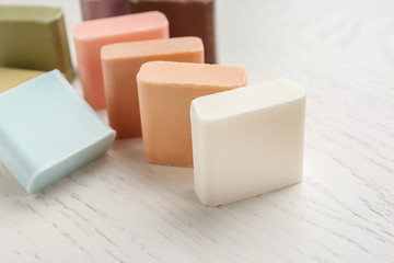 Fototapeta na wymiar Different soap bars on white table