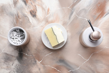 Soap and cotton swabs on table