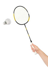 Hand with badminton racket and feather shuttlecock