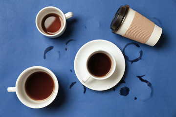 Almost empty cups of coffee on color background. Concept of addiction