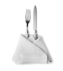 Cutlery and napkin on white background