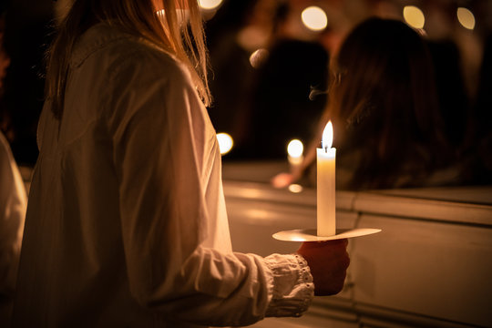 People handling candles in the hands. Christmas and lucia holidays in Sweden