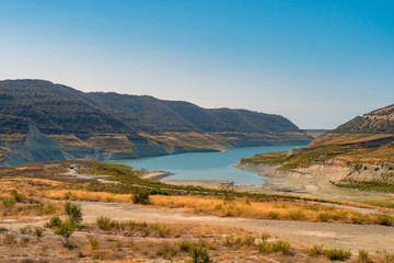 Fototapeta na wymiar Picture of blue lake between mountains in the desert, Cyprus