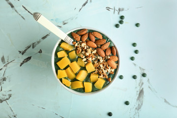 Bowl with spirulina smoothie on light table