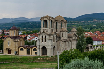 View of public garden with new orthodox church  in  residential district, town Delchevo among...