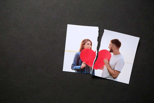 Torn Photo Of Happy Couple On Dark Background. Concept Of Divorce