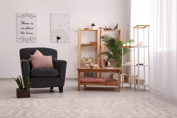 Interior of modern room with table and comfortable armchair