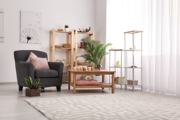Interior of modern room with table and comfortable armchair