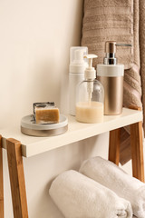 Fototapeta na wymiar Soap and body care cosmetics on stand in bathroom