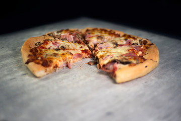 Sliced pizza on grey