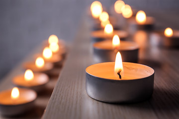Burning candles on table, closeup