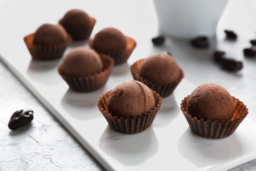 Tasty sweet truffles on white board