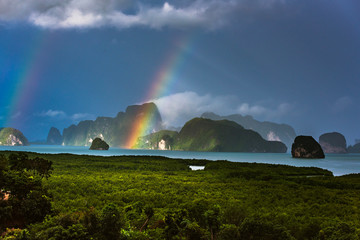 A rainbow appears over the island of Phuket. This ocean of India tropical island is one of the most beautiful in the world.