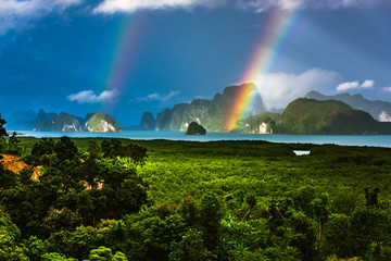 A rainbow appears over the island of Phuket. This ocean of India tropical island is one of the most...
