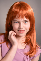 Close up portrait of cute girl with red hair posing