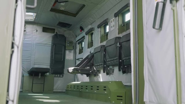 Inside view of military car. Children get into it