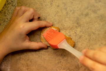 Child shaping and cutting baking cookies for christmas