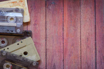 Old cassette tapes on the wooden table