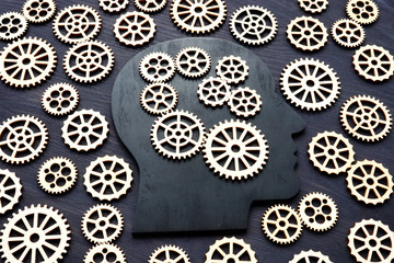 Emotional intelligence EI. Head silhouette with gear wheels.