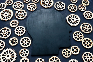 Emotional quotient EQ. Head silhouette and gears around.