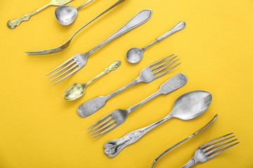 Set of cutlery on color background