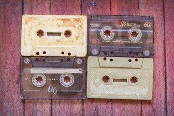 Old cassette tapes on the wooden table