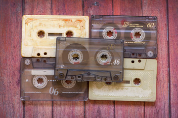 Old cassette tapes on the wooden table