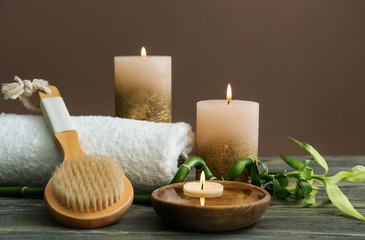 Fototapeta na wymiar Beautiful spa composition with burning candles on wooden table