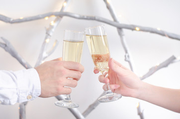 Two hands with glasses of champagne.