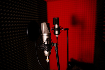 Open empty microphone on stand in red recording Studio