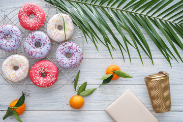 Composition with tasty doughnuts on wooden table