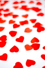 A lot of small red hearts on an isolated background.