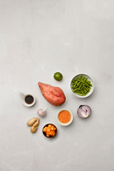 A selection of vegetable ingredients and soy sauce on a marble table top